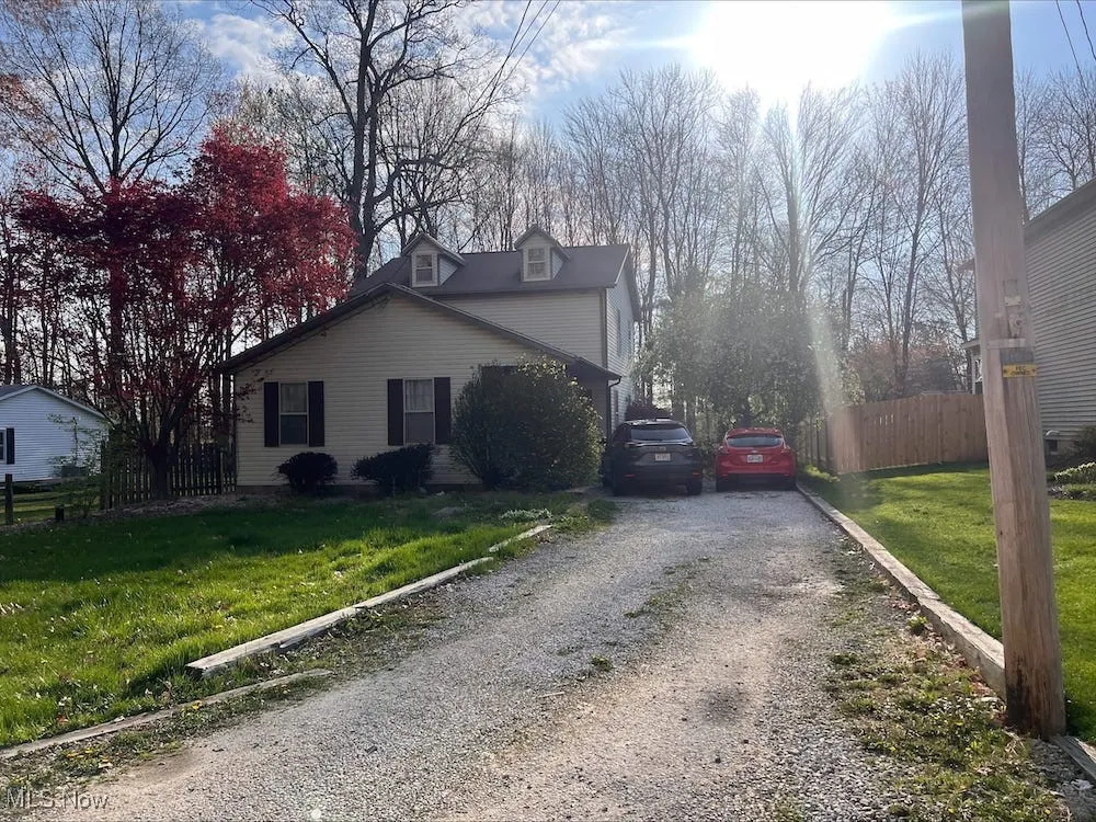 View of home's exterior with gravel driveway