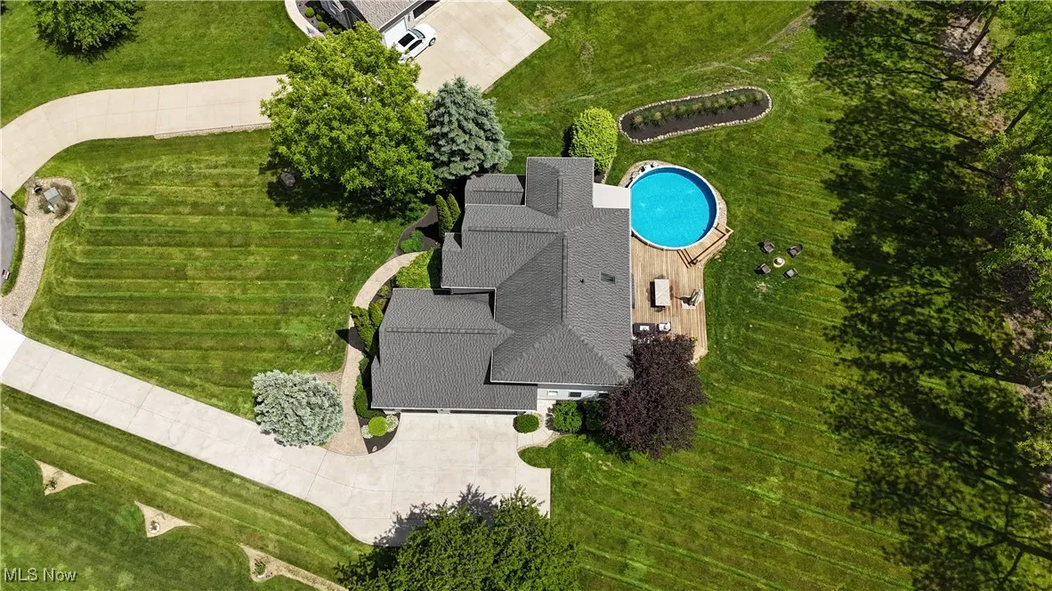 View of subject property with a pool area