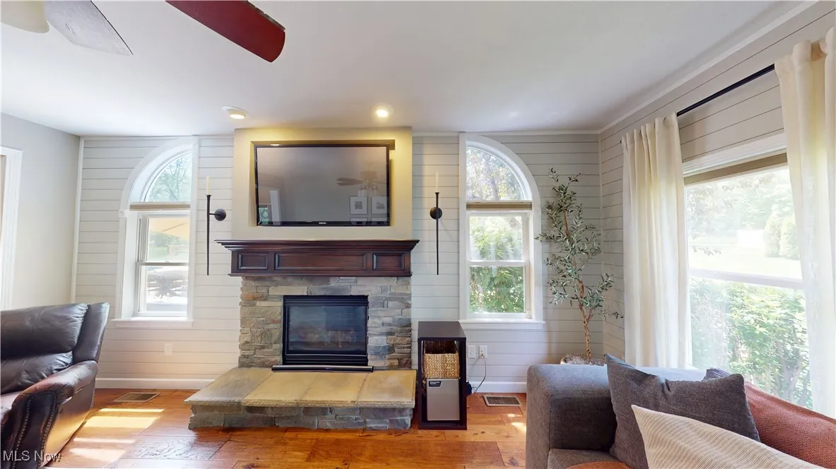 Living area with wood finished floors and a fireplace
