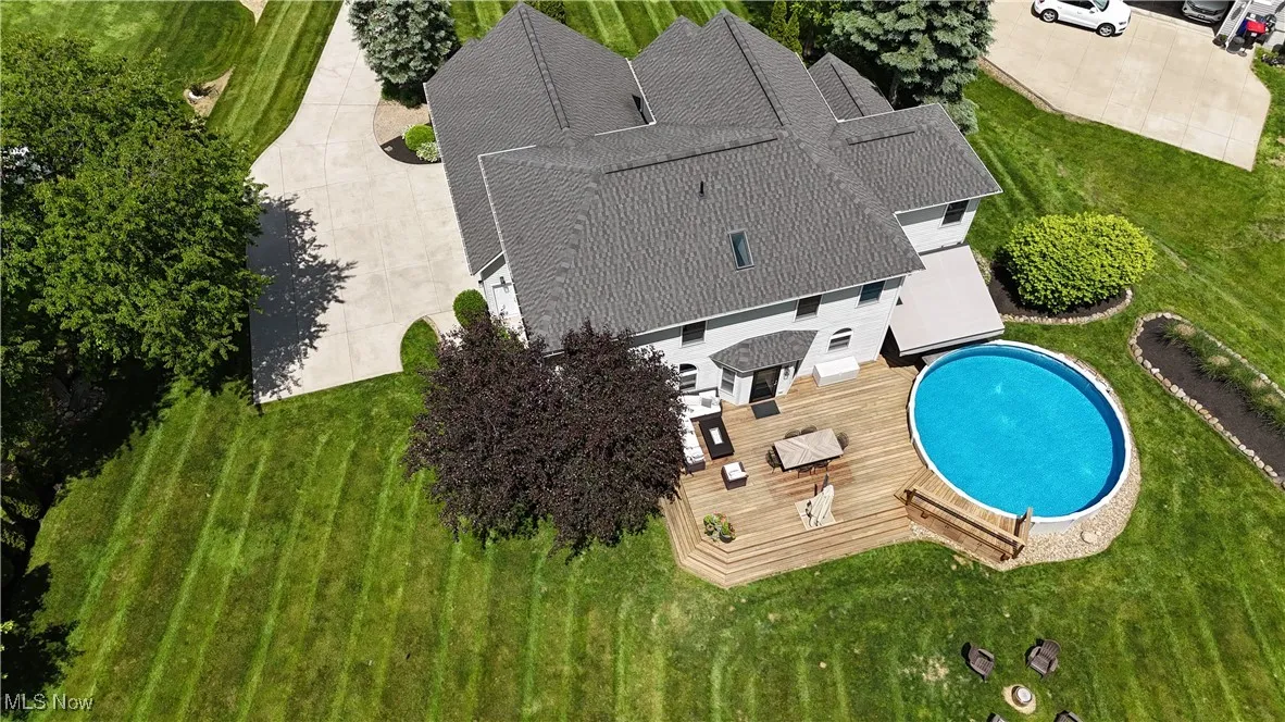 Aerial view of property and surrounding area with a pool area
