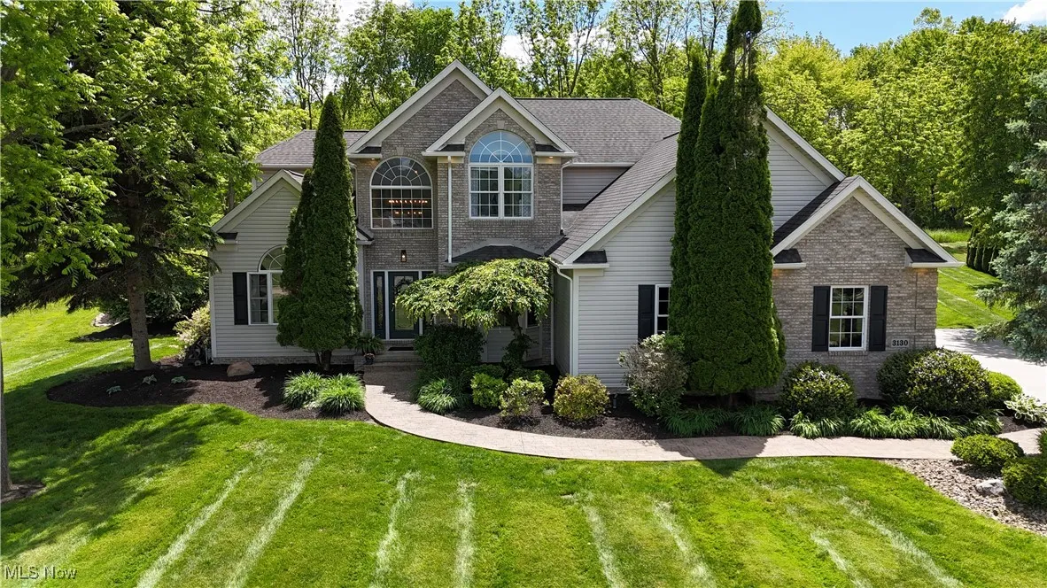 View of front of home featuring a front yard and brick siding