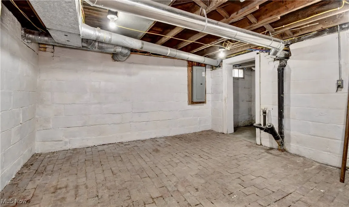 Unfinished basement with electric panel