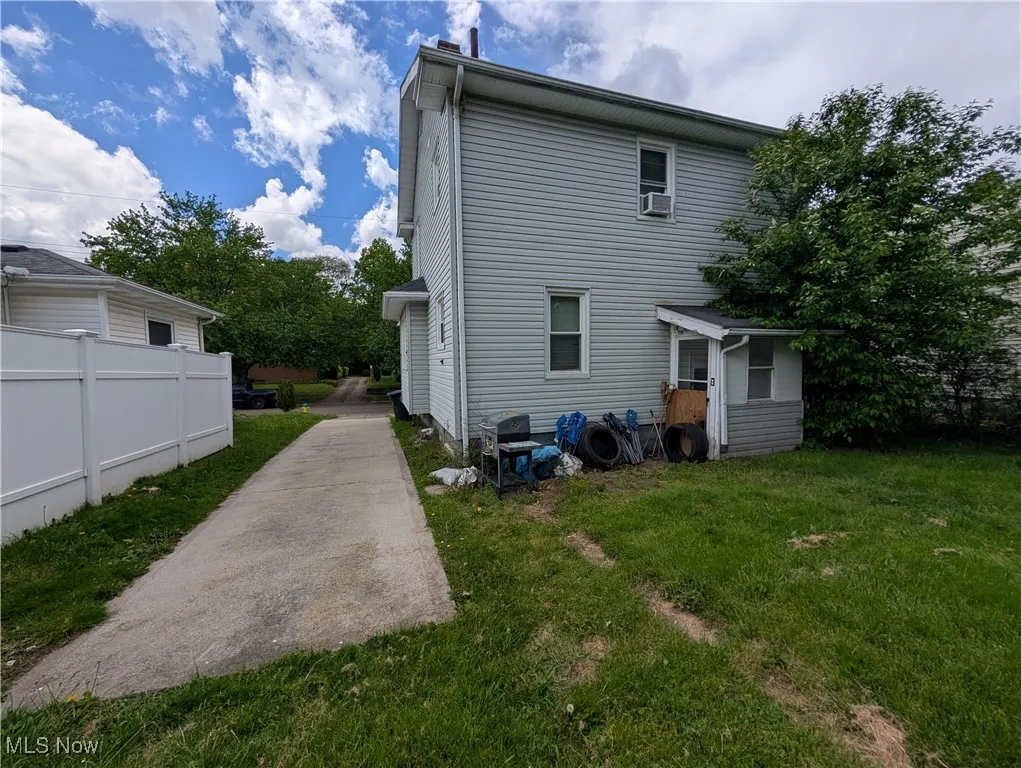 Rear view of property with cooling unit