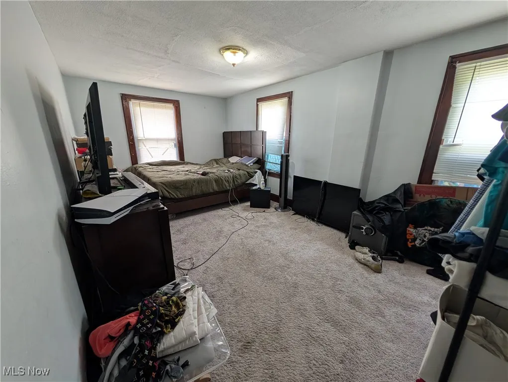 Bedroom with carpet floors and a textured ceiling