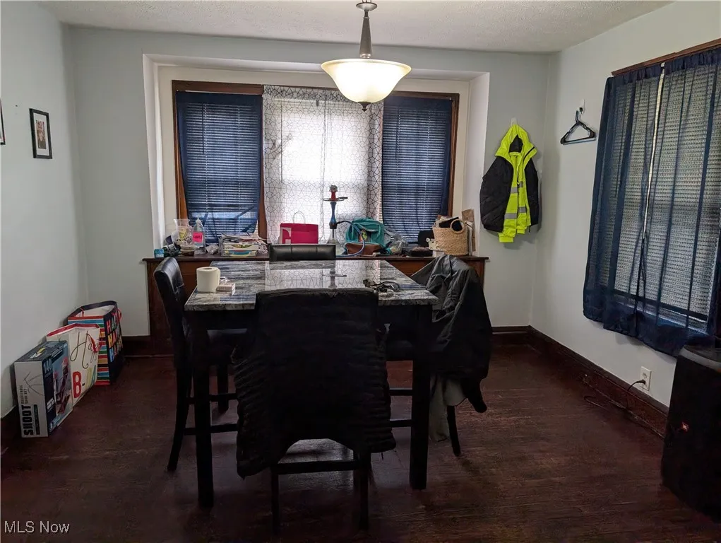 Dining room featuring wood finished floors and baseboards