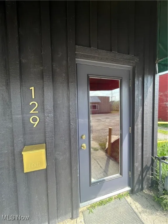Entrance to property featuring board and batten siding