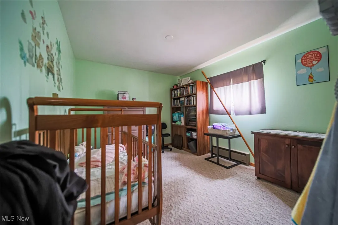 Bedroom with carpet flooring and baseboards