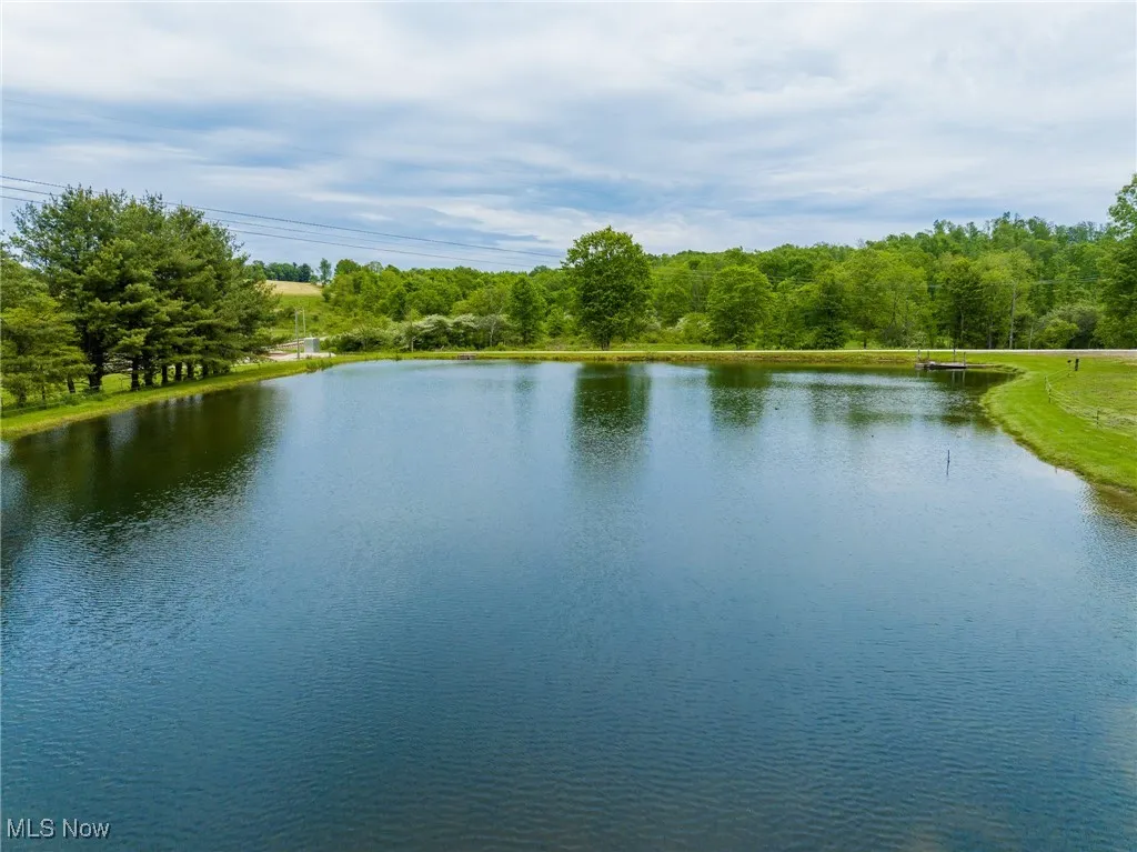Water view with a heavily wooded area