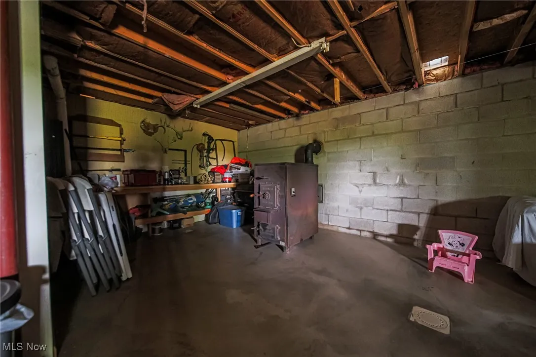 Below grade area featuring concrete block wall