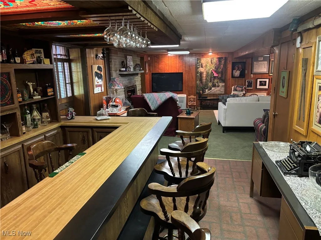 Indoor dry bar with brick patterned floors and wooden walls