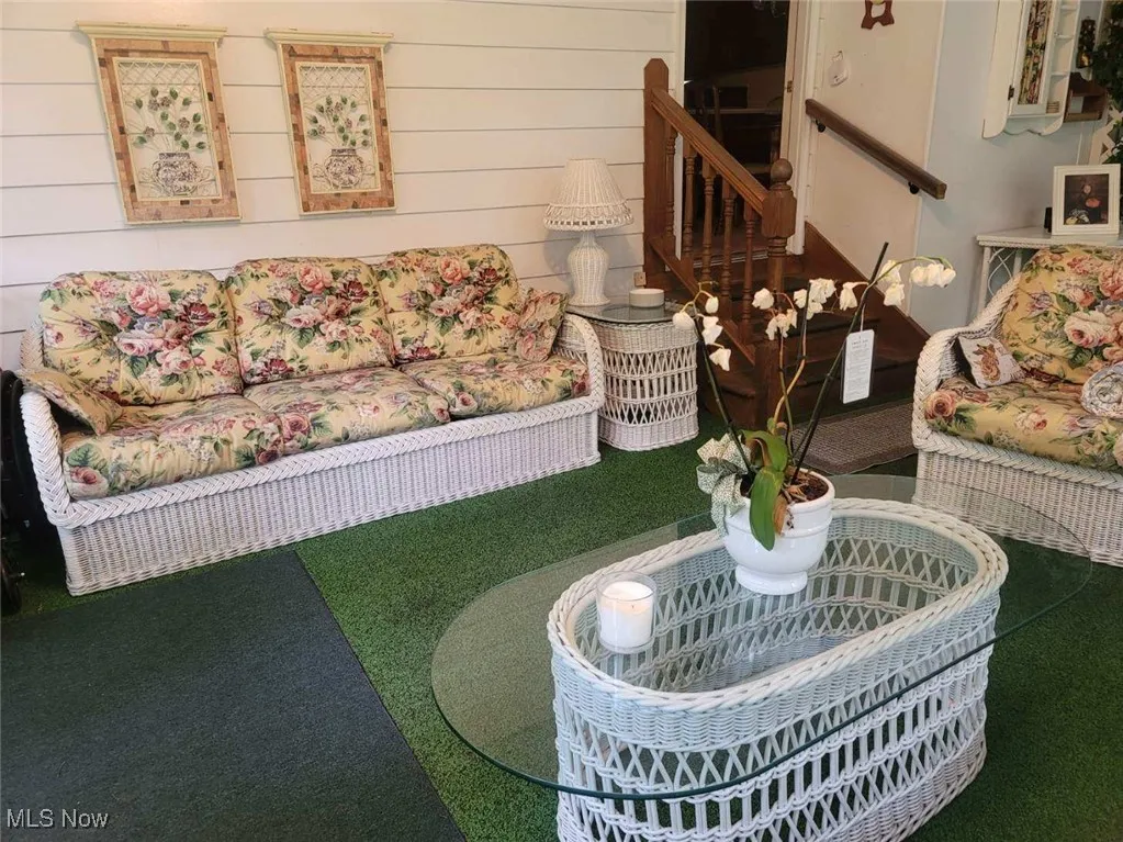 Carpeted living area featuring stairs