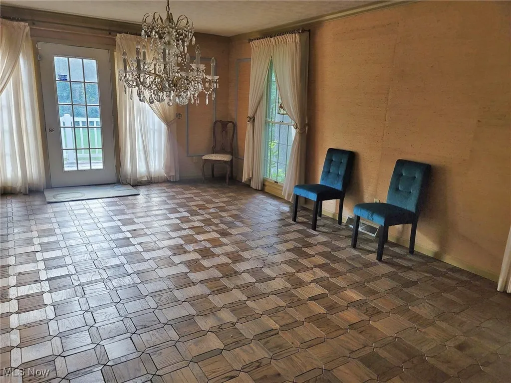 Unfurnished room featuring a chandelier