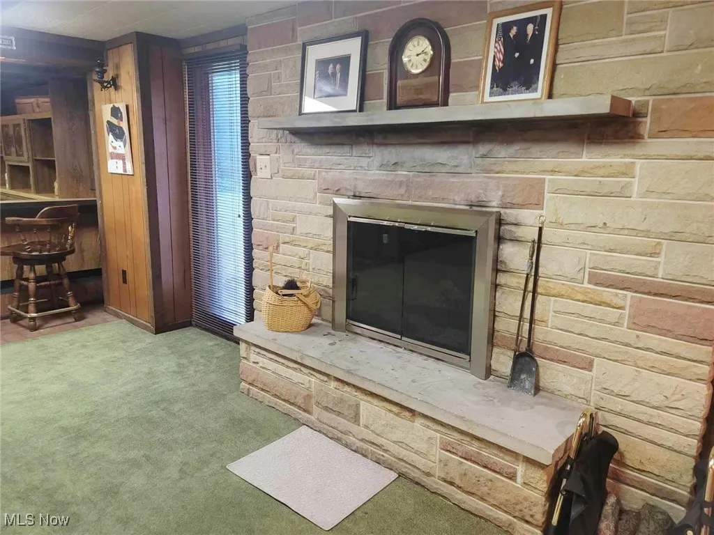 Detailed view of carpet flooring and wood walls