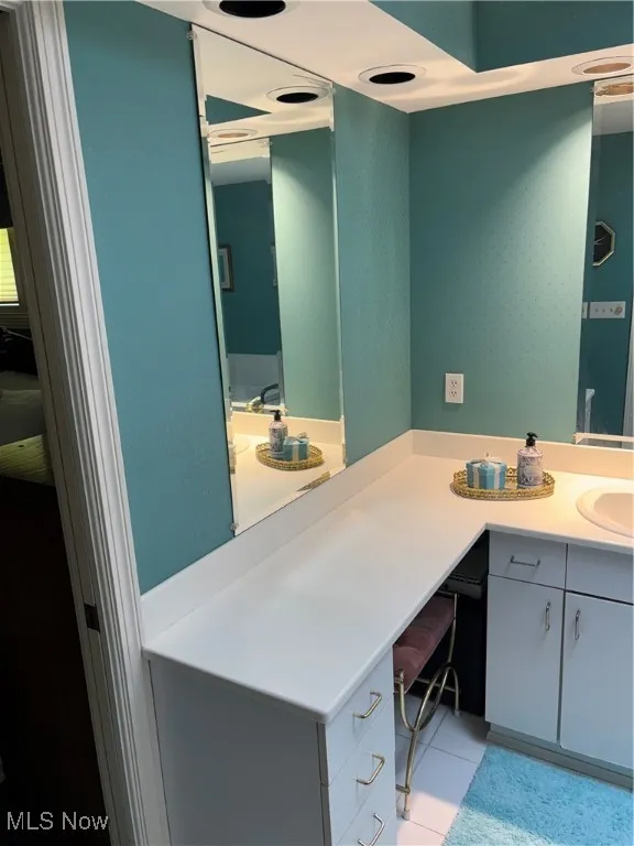 Bathroom featuring vanity and tile patterned floors