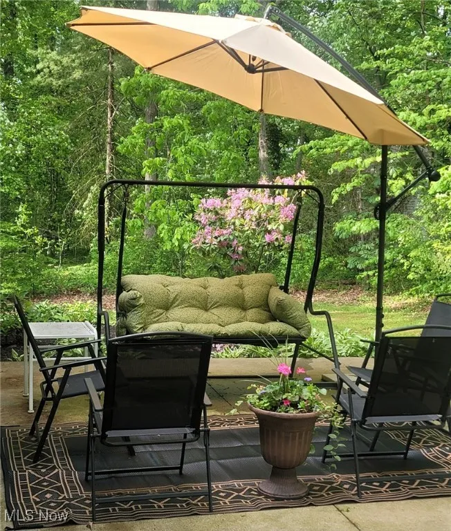 Balcony featuring a wooded view