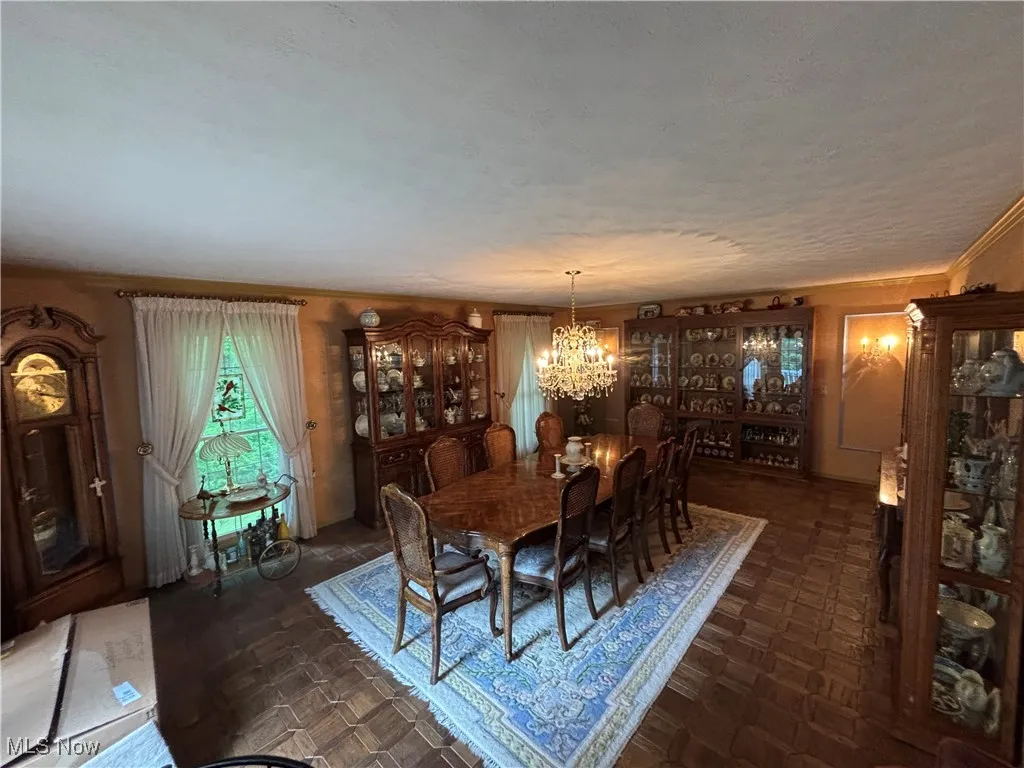 Dining space with a chandelier and a textured ceiling