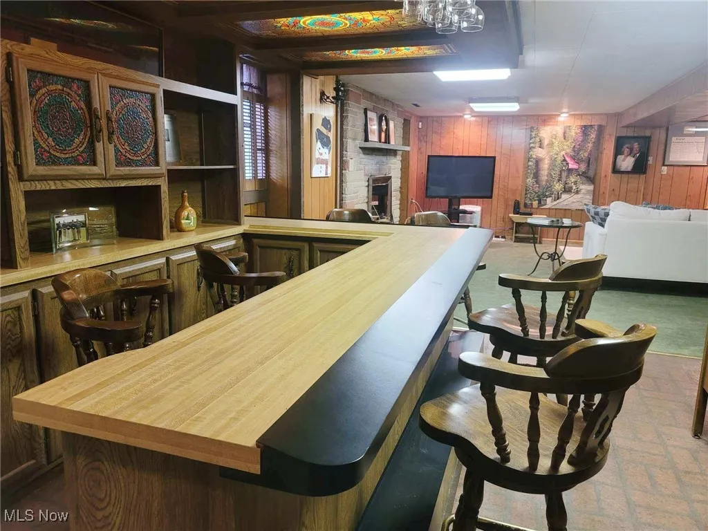 Indoor dry bar featuring wood walls