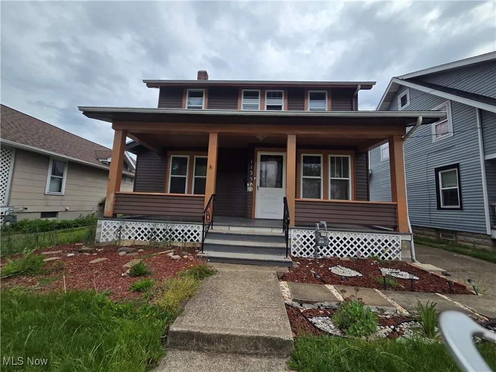 Bungalow with covered porch and a chimney