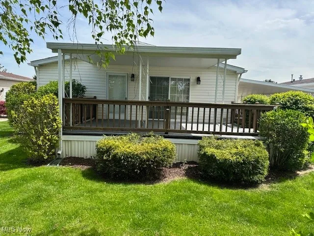 Back of property with a yard