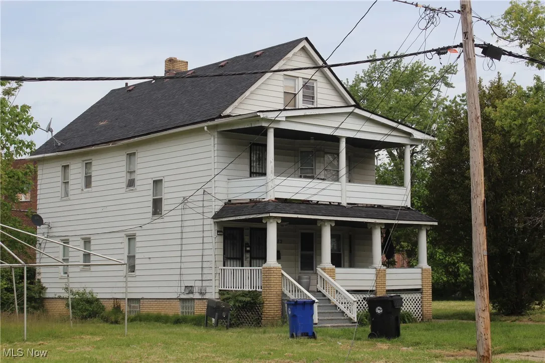 South side of Property, porch, a balcony, and a shingled roof