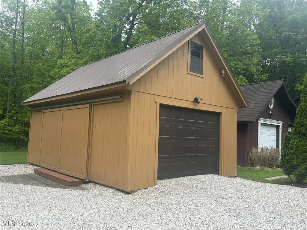 Detached garage with gravel driveway