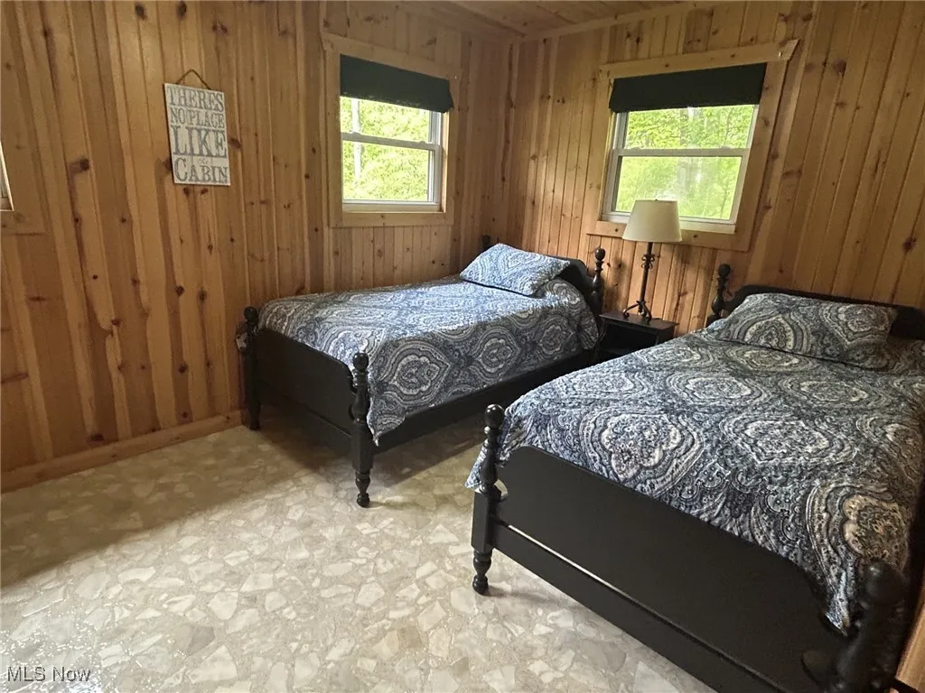 Bedroom featuring wood walls