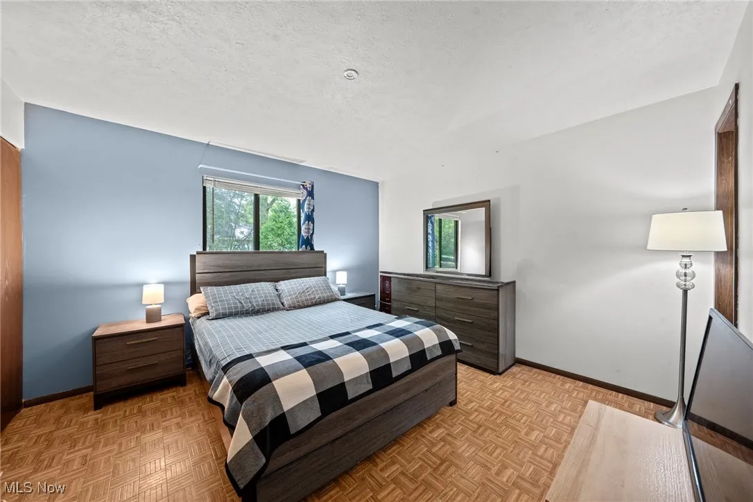 Bedroom featuring baseboards and a textured ceiling