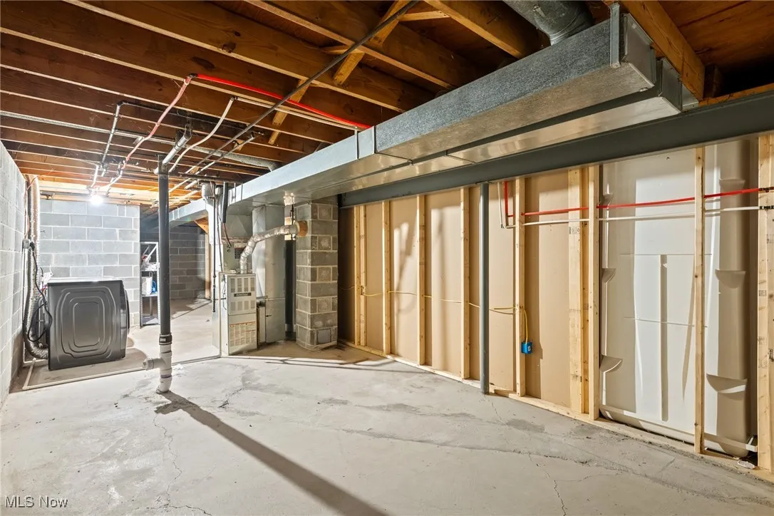Unfinished below grade area with concrete block wall