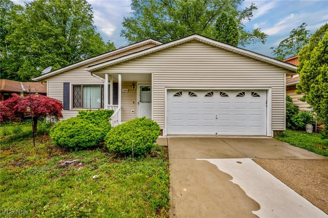 Ranch-style home featuring concrete driveway and an attached garage