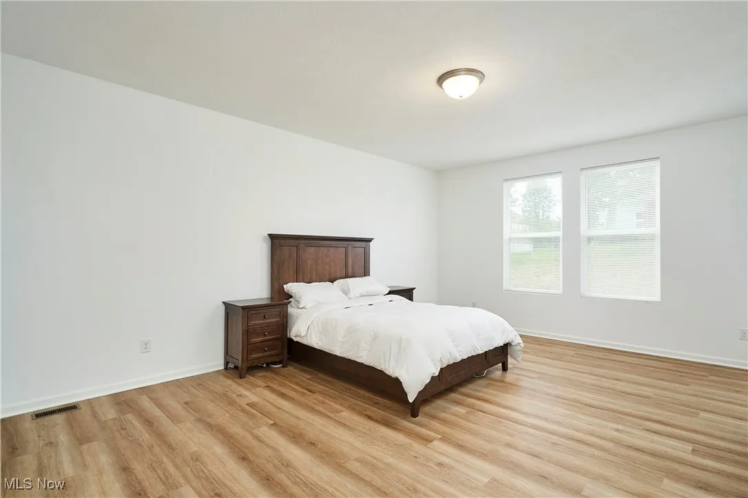 Bedroom featuring light wood-style flooring and baseboards