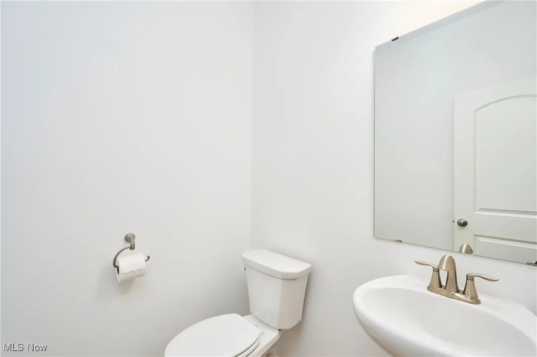 Half bathroom with a sink and toilet