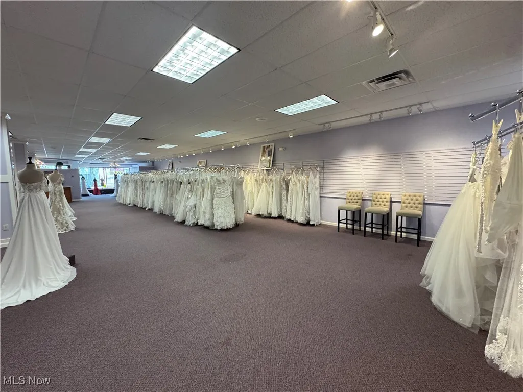 Miscellaneous room with carpet flooring, a paneled ceiling, and track lighting