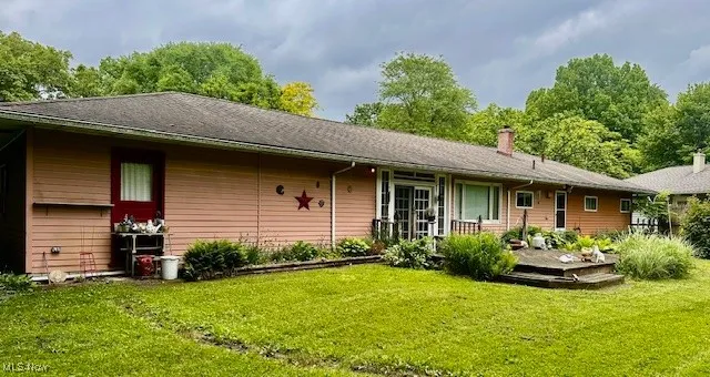 Rear view of property featuring a deck