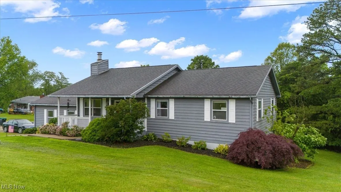 Nicely landscaped front walkway brings you to the front porch.