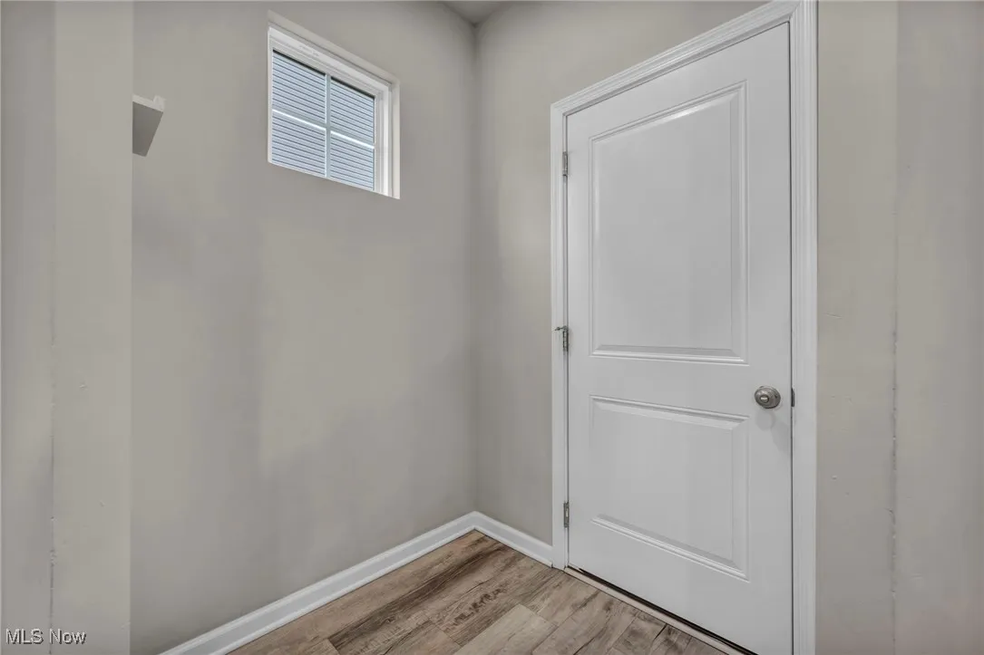 Entryway with light wood-style flooring and baseboards