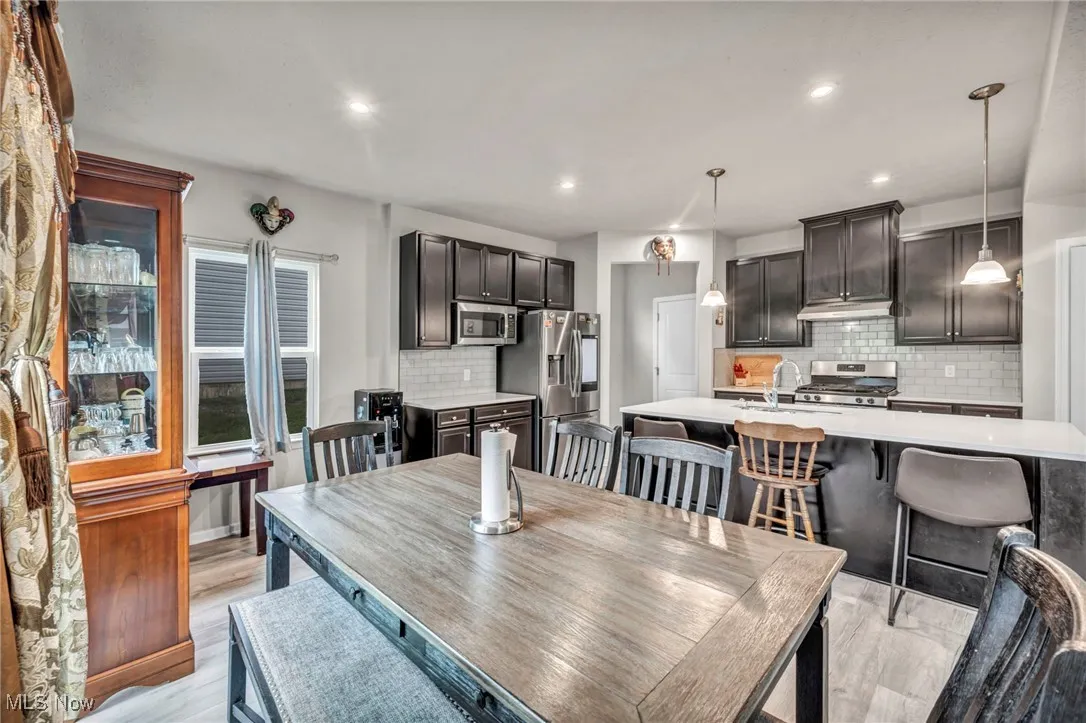 Dining area featuring recessed lighting and light wood-style flooring