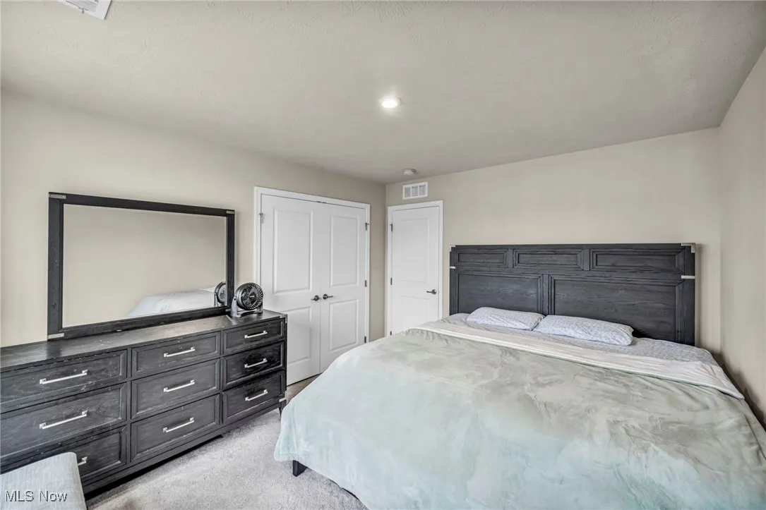 Bedroom featuring light carpet, a closet, and recessed lighting