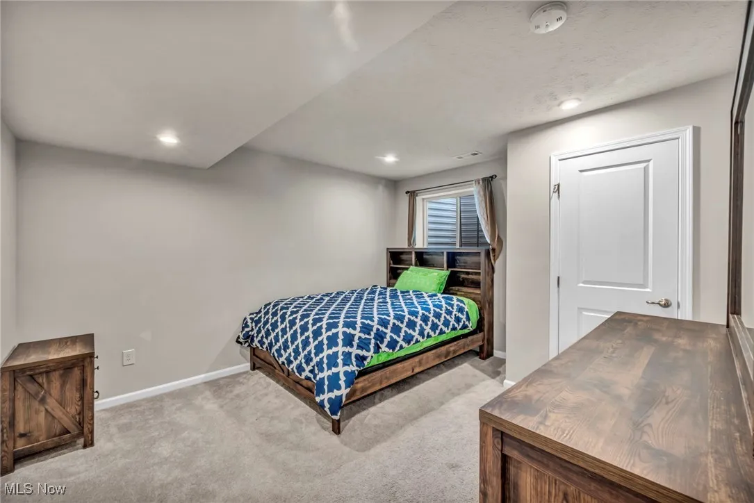 Carpeted bedroom featuring baseboards and recessed lighting
