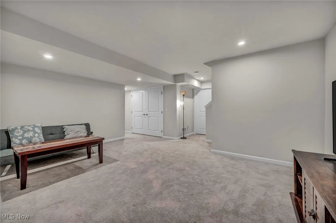 Sitting room featuring light carpet, recessed lighting, and baseboards