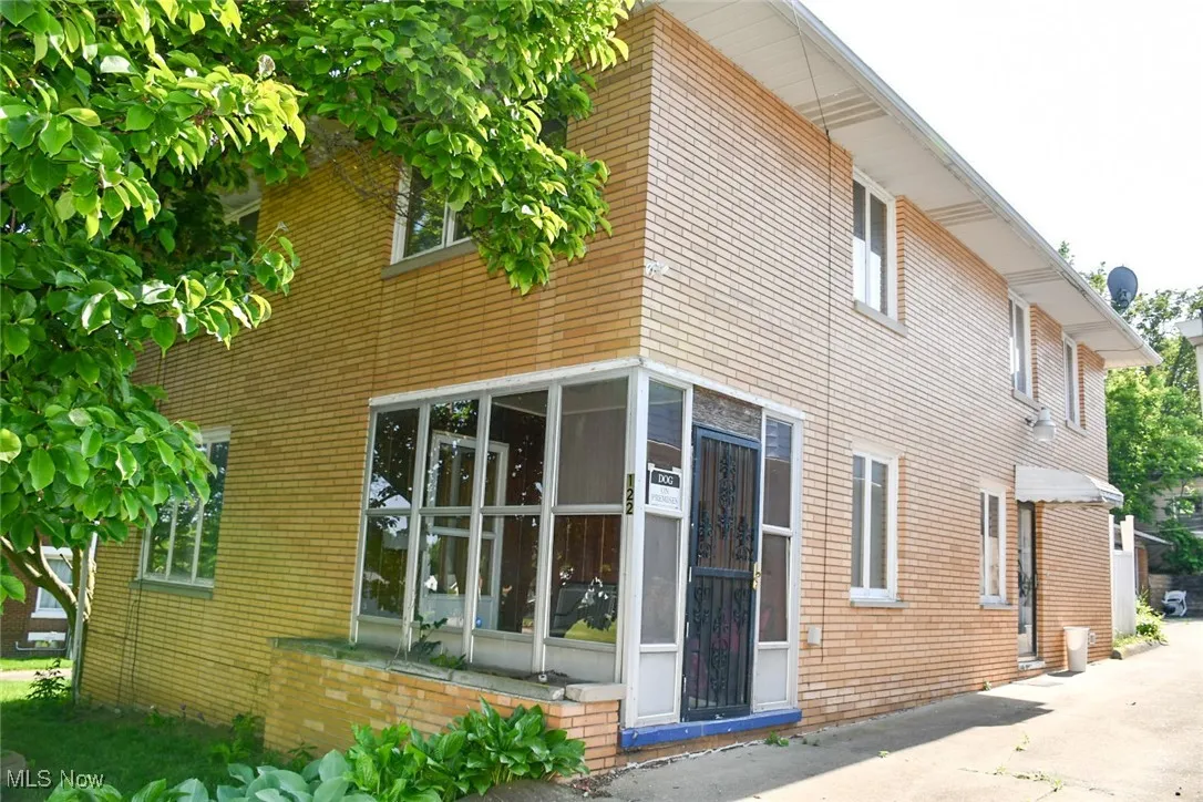 View of side of property featuring brick siding