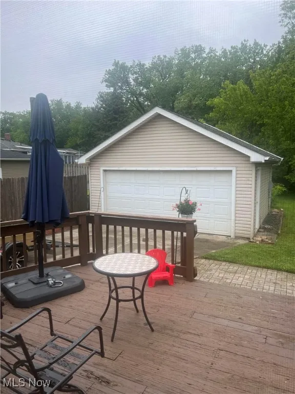 Deck featuring a garage and an outdoor structure