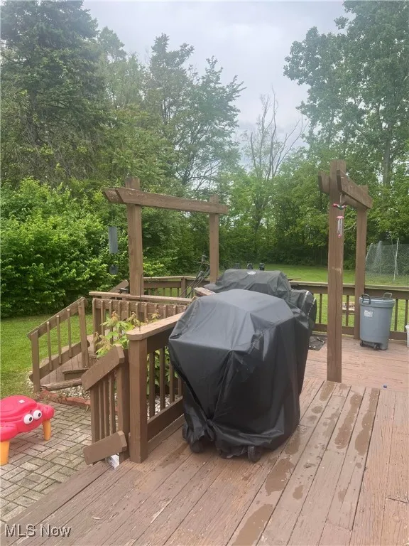Wooden deck featuring view of wooded area