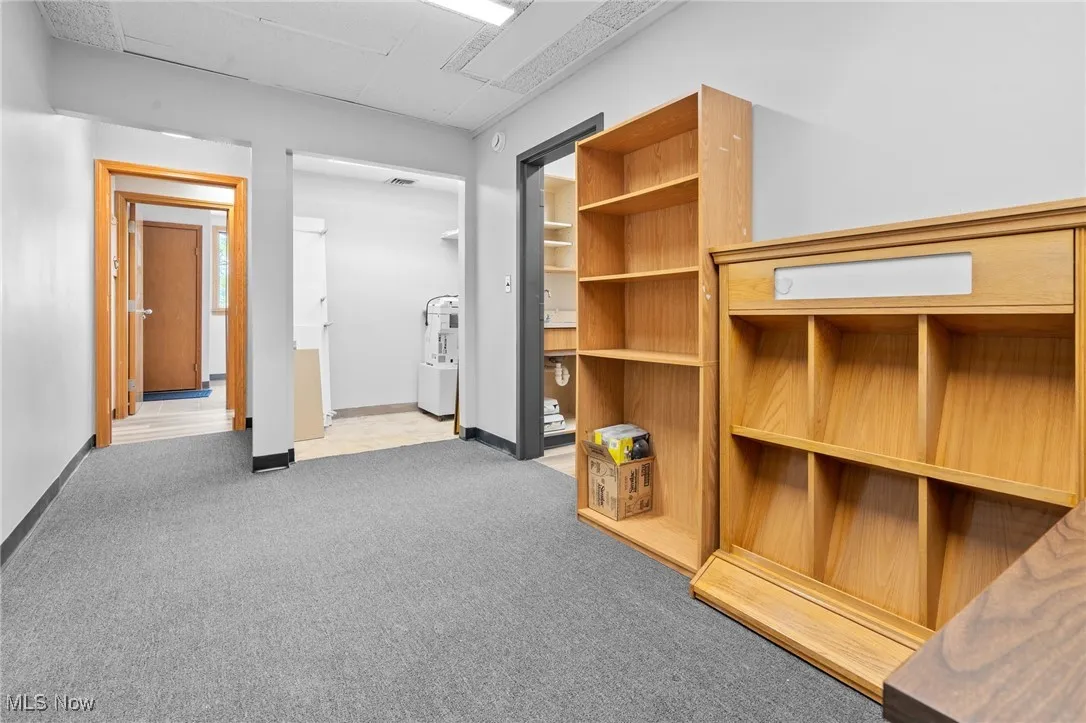Large office with bookcases and copier area.
