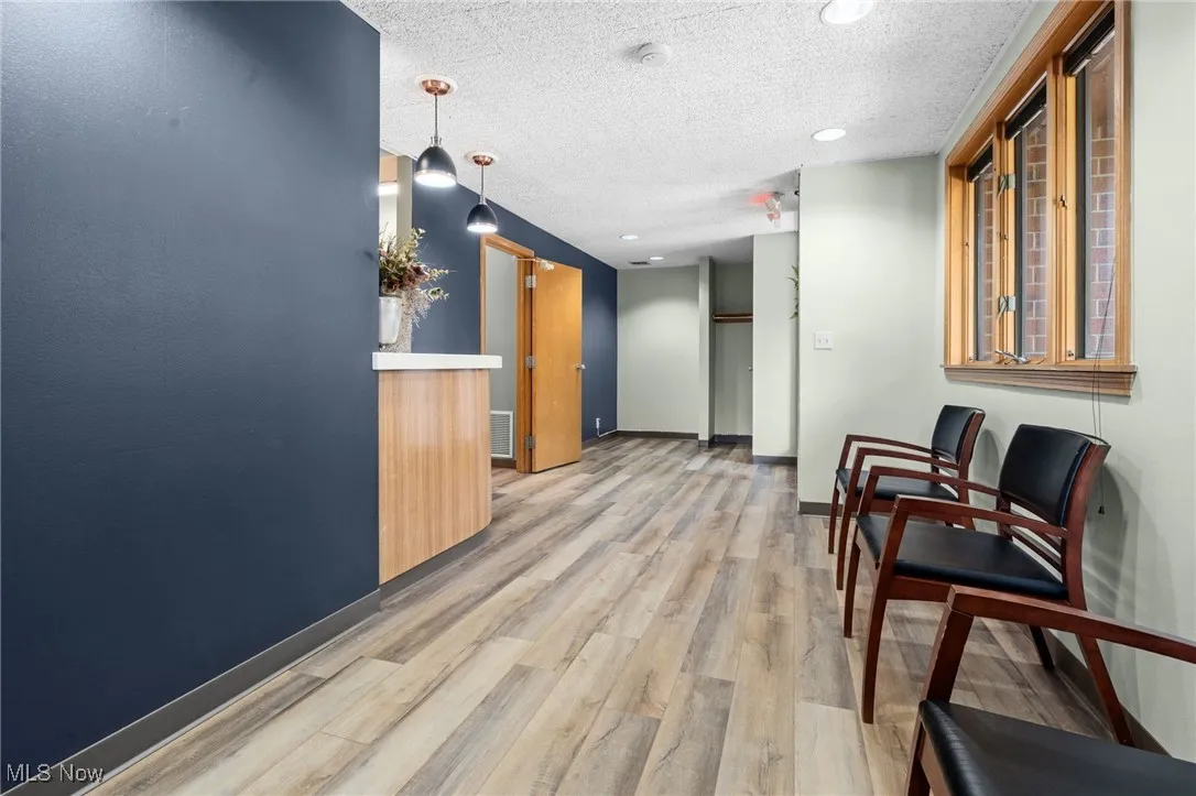 View of waiting area. Looking towards reception desk and front entry