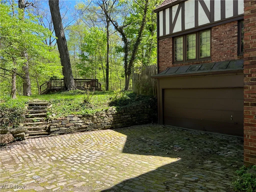 Stone staircase to upper back yard with deck