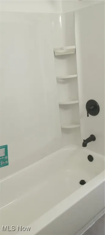 Full bathroom with shower / bathtub combination