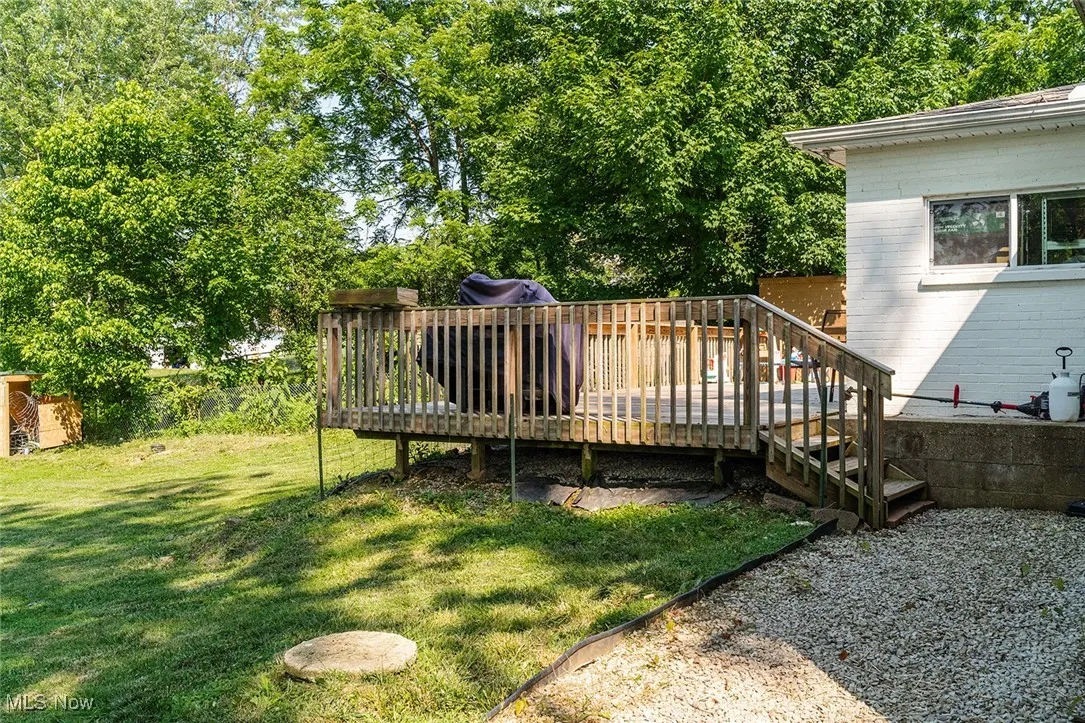 View of grassy yard with a deck