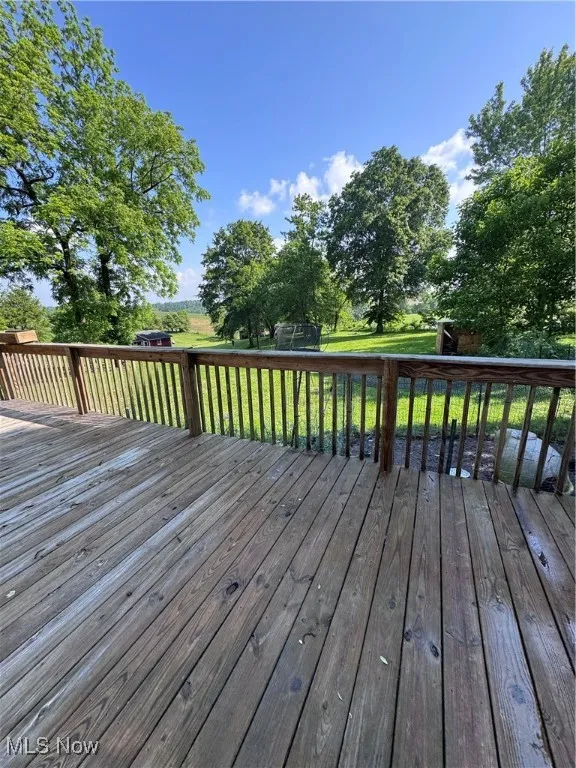 Wooden deck with a yard and a trampoline