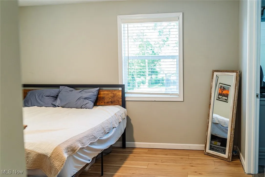 Bedroom with light wood-type flooring and baseboards