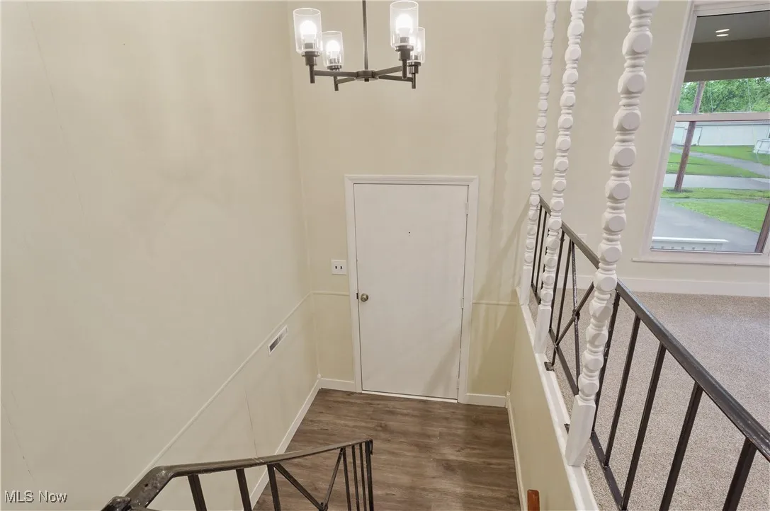 Stairway featuring wood finished floors and baseboards